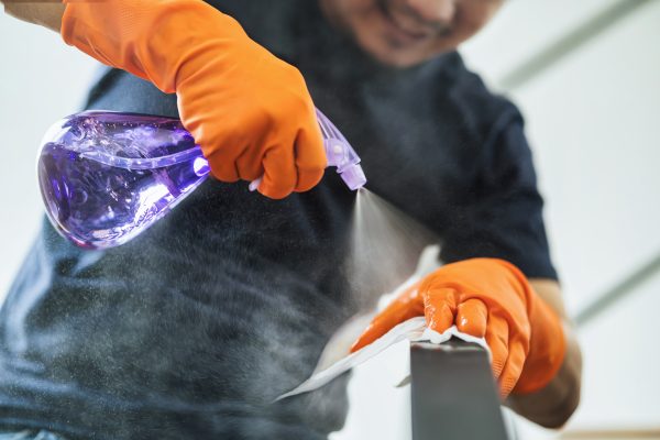 Asian man hand spraying to staircase of house for cleaning by tower in covid19 outbreak and pandemic,healthcare and protection against virus,social distancing and responsibility by quarantine concept