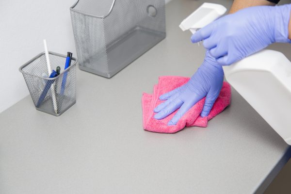 Woman at work, professional maid cleaning in dental office