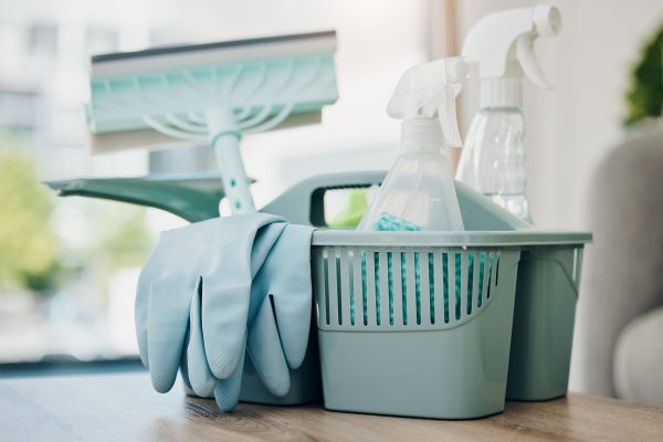 Shot of a basket with cleaning supplies on a table.